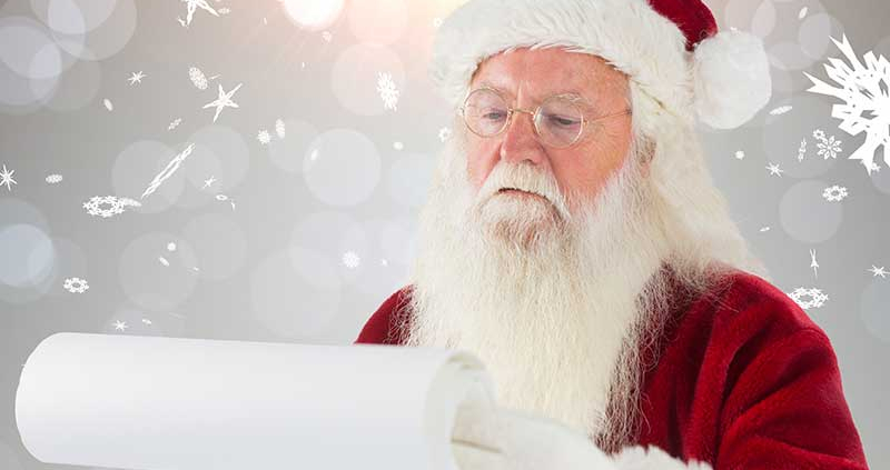 Santa Claus reading a list on a scroll. The background is grey with snowflakes.